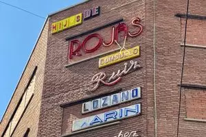 Commercial Signage on the Façade of Gruta 77 in Madrid, Spain